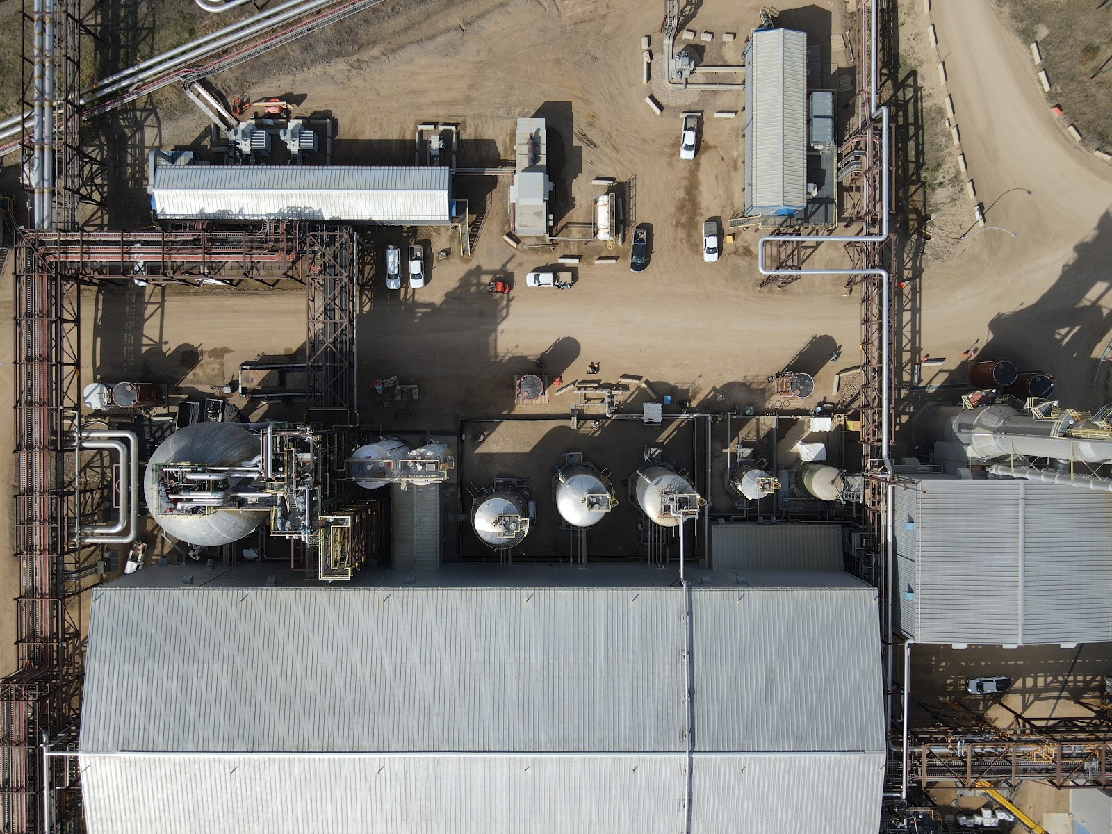 Aerial drone view of a refinery and tank farm at golden hour