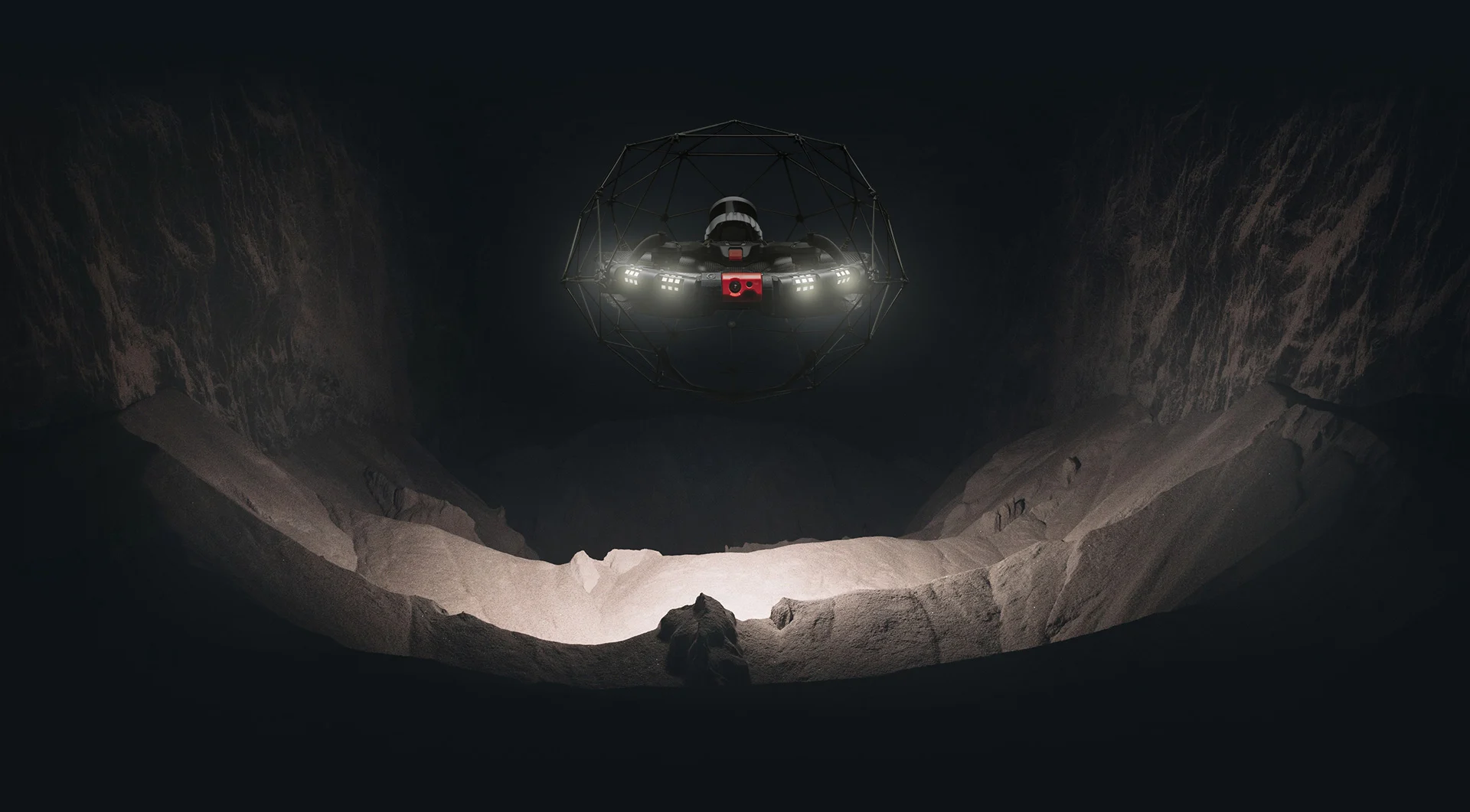 Caged inspection drone illuminating a dark underground cavern
