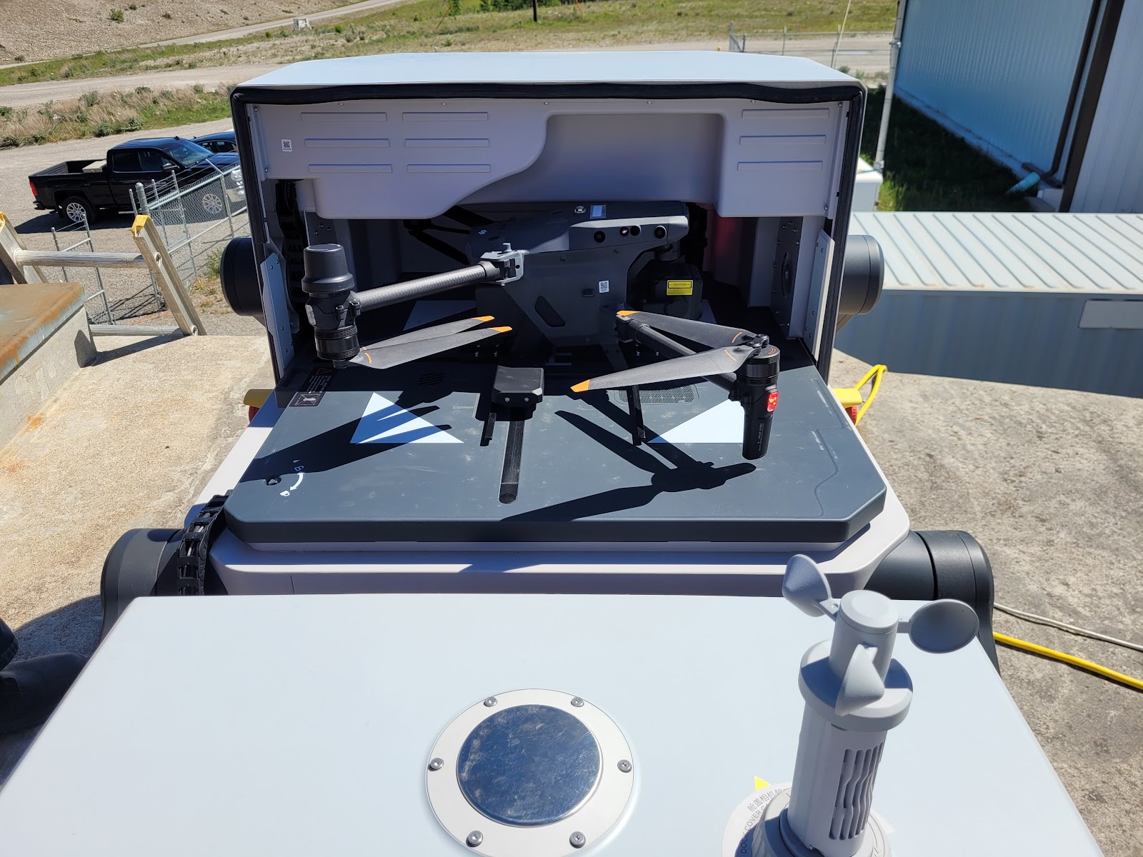 Autonomous drone-in-a-box dock on a gravel pad